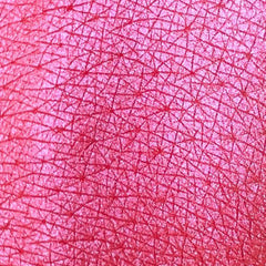 Close-up of Tala Rose Wine R1 Eye Shadow Pigment in a small glass jar with rose gold lid and deep wine-colored powder