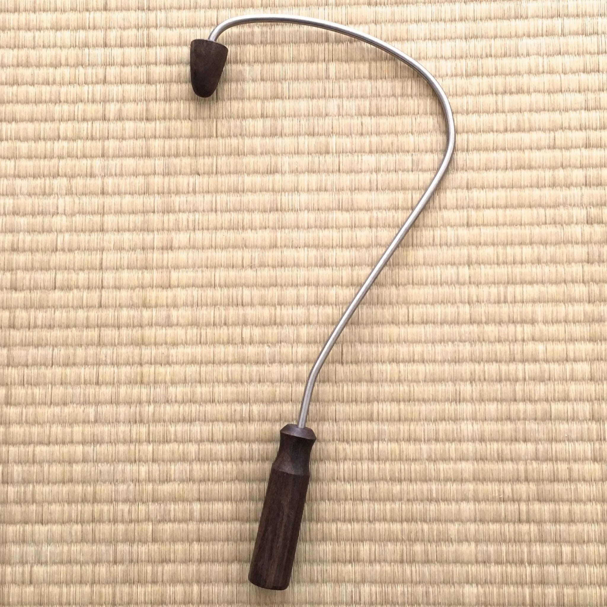 Acupressure back massage tool, silver metal and dark wood handle, curved design