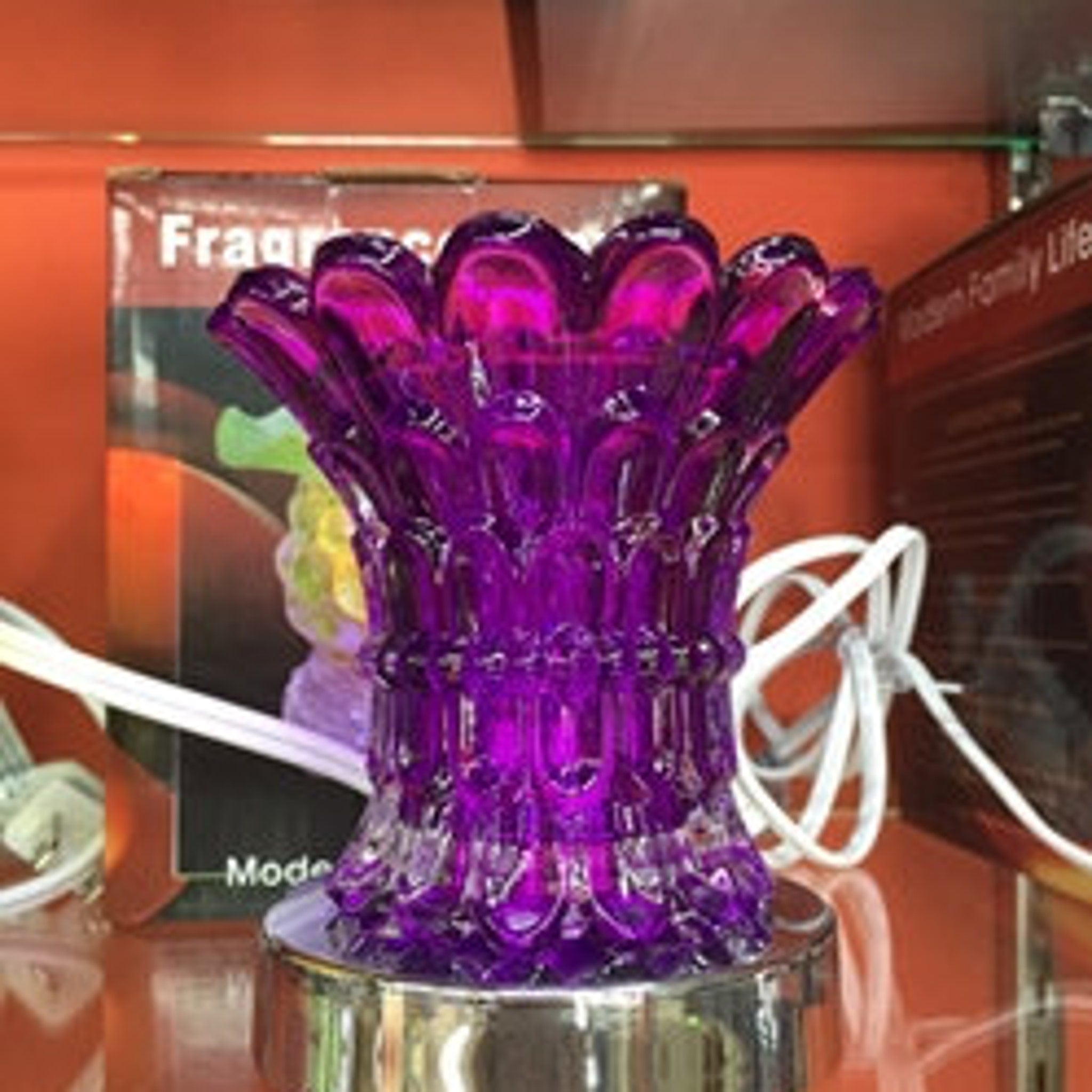 Purple glass oil warmer with floral design and silver base