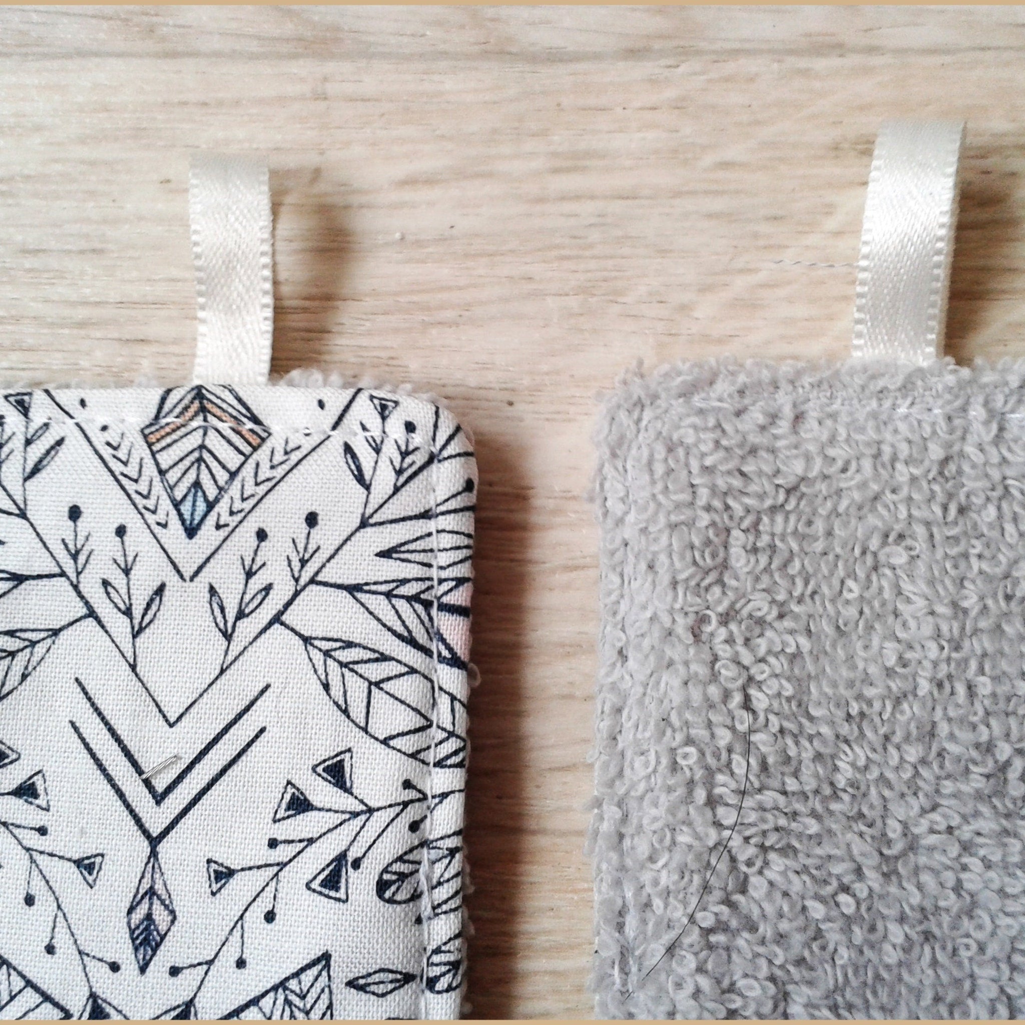 Washcloths with white ribbon, gray terry cloth, and patterned fabric with leaf design