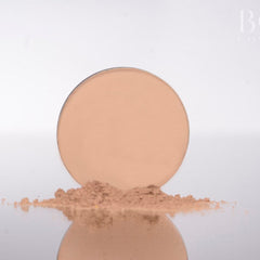 Close-up of soft pink matte eyeshadow pan showing smooth pressed powder texture