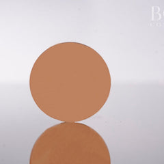 Single pressed eyeshadow pan in warm golden brown matte finish, 37mm diameter