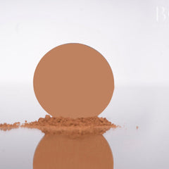 Close-up of matte golden brown eyeshadow pan showing smooth, pigmented powder texture