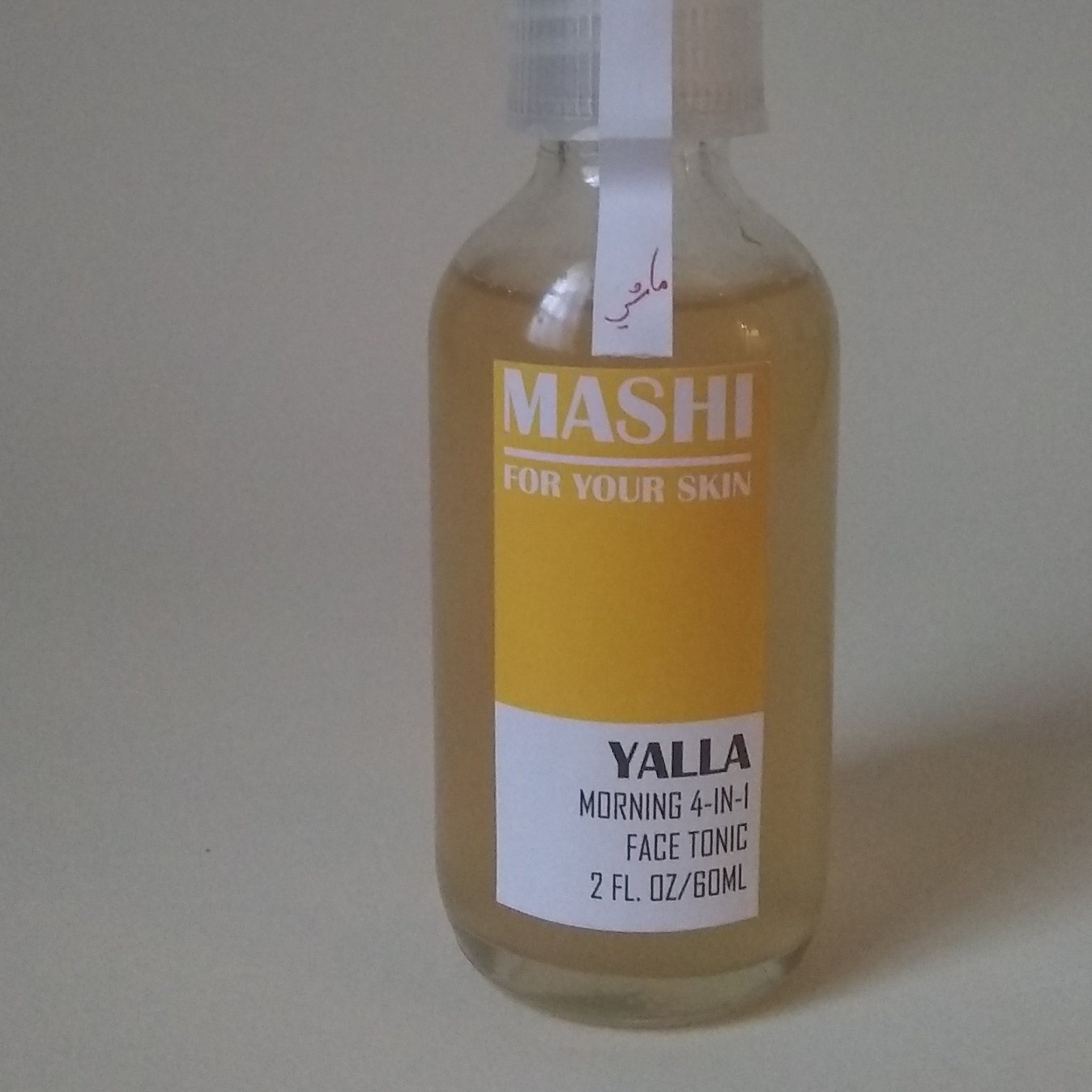 Toner bottle with yellow label and clear glass, MASHI Yalla face tonic
