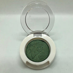 Green eyeshadow with white compact and clear lid open, makeup product
