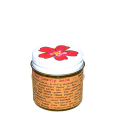 Close-up of pink Beach Rose Nourishing Beauty Balm with creamy texture in minimalist white jar