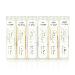 Lip balm tubes with white, gold, and colored labels, Wild Jasmine brand, for lip care