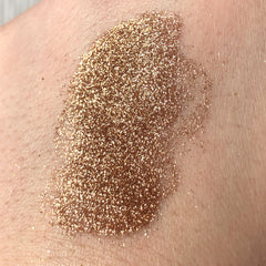 Side view of Tala Cafe au Lait glitter eye shadow pigment in a small 2ml tube with metallic sheen