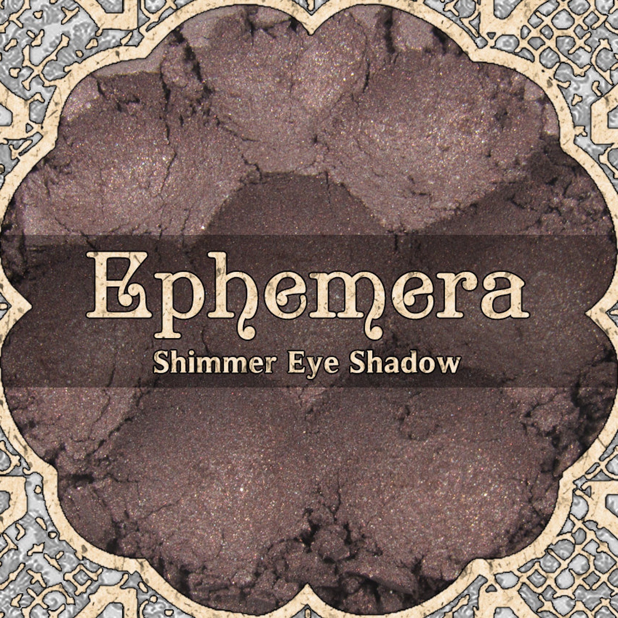 Close-up of EPHEMERA loose powder eyeshadow in shimmering cool mauve and chocolate brown, vegan formula in minimalist jar