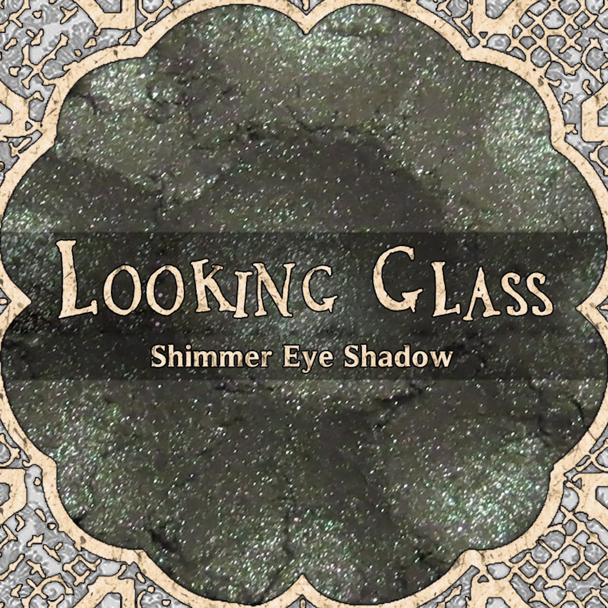 Grey duochrome loose powder eyeshadow with shimmer finish in a clear glass jar, vegan formula