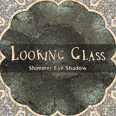 Grey duochrome loose powder eyeshadow with shimmer finish in a clear glass jar, vegan formula