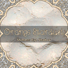 Orange Stardust loose eyeshadow with iridescent shimmer in a clear jar, vegan cosmetic powder