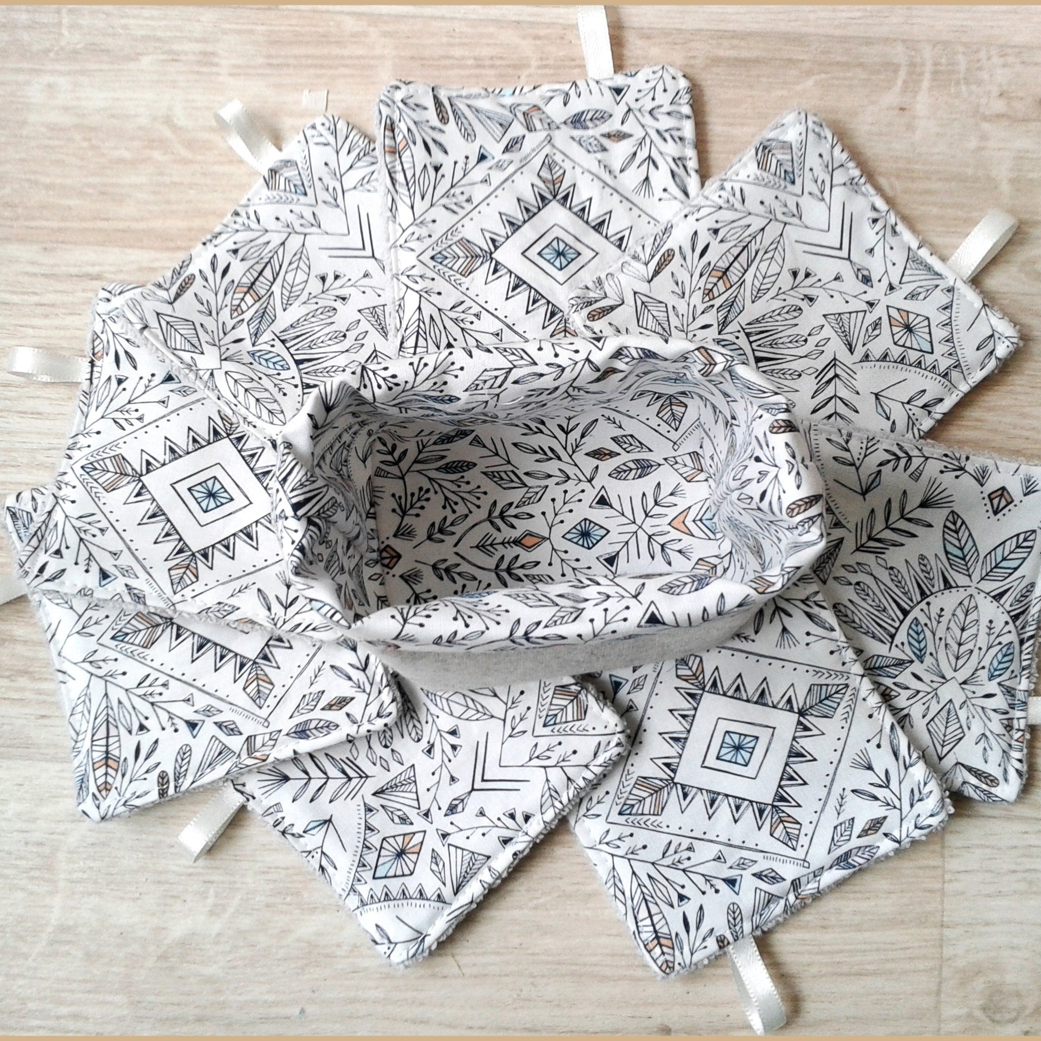 Fabric basket with matching patterned coasters, white with black and muted color design, fabric with ribbon loops