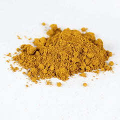 Close-up of loose mineral eye shadow powder with shimmering mica pigments in a glass jar
