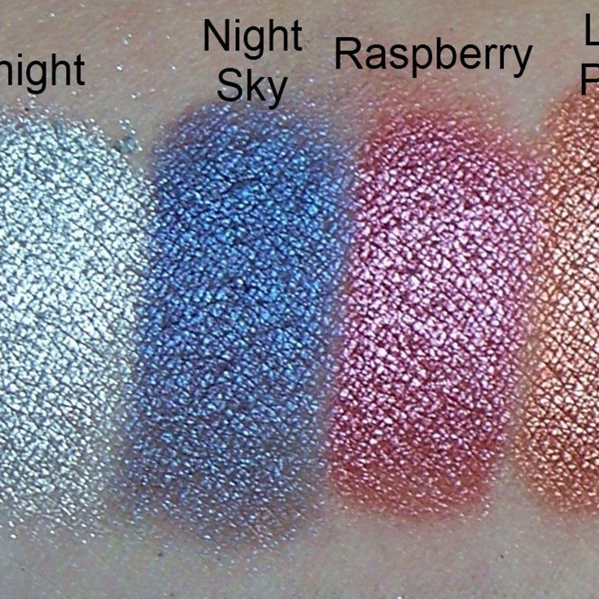 Eyeshadow swatches, metallic Night Sky, Raspberry, and Light Peach colors on skin