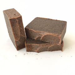 Frankincense soap, brown rectangular bars, speckled texture, stacked on white surface