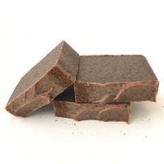 Soap bars in brown with speckled texture and rough edges, stacked together