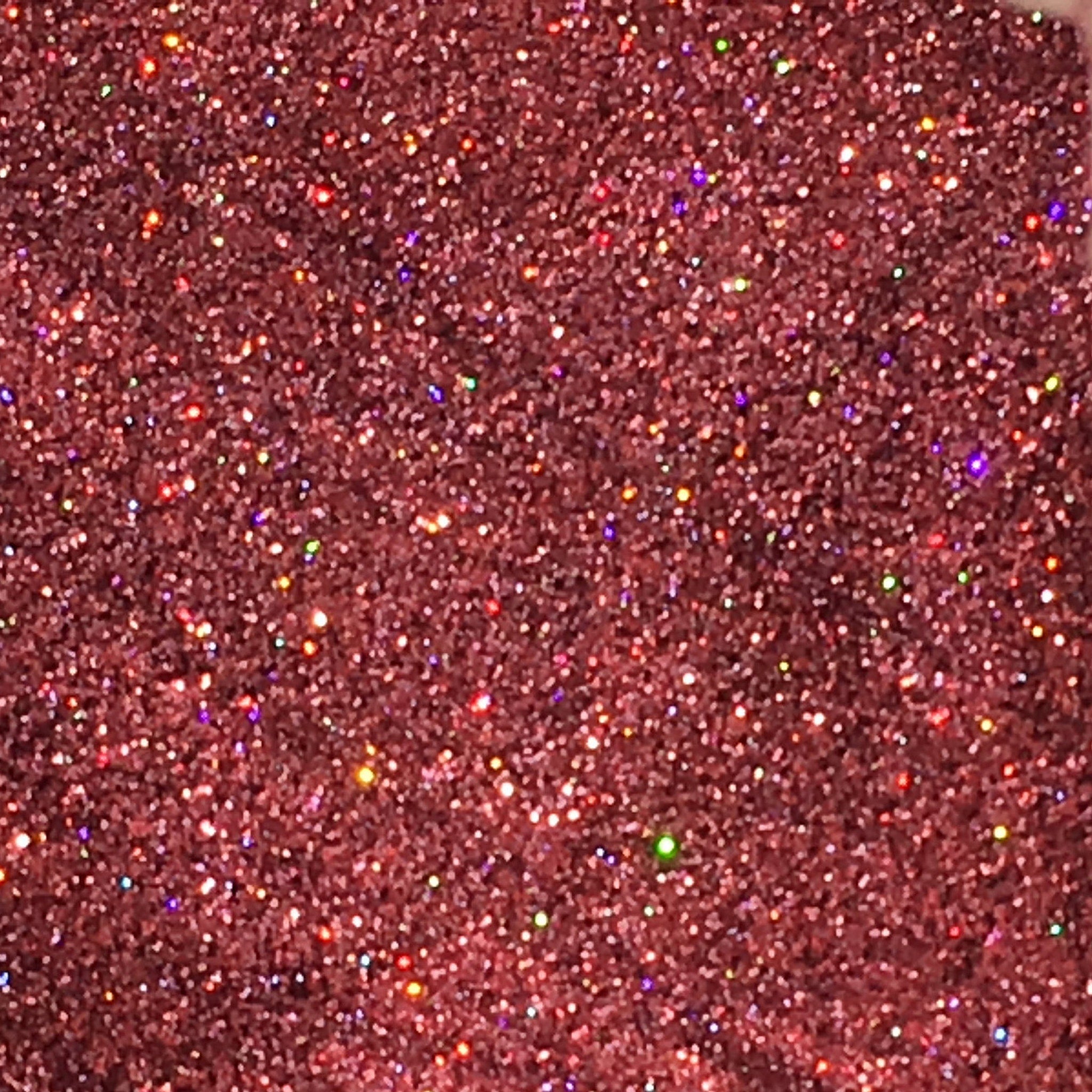 Side view of holographic pink glitter eyeshadow pot showing ultrafine sparkle texture and reflective finish