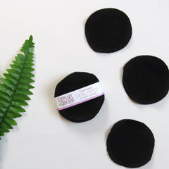 Facial rounds, black circular cotton pads with stitched edges, Farm Girl Design branding visible