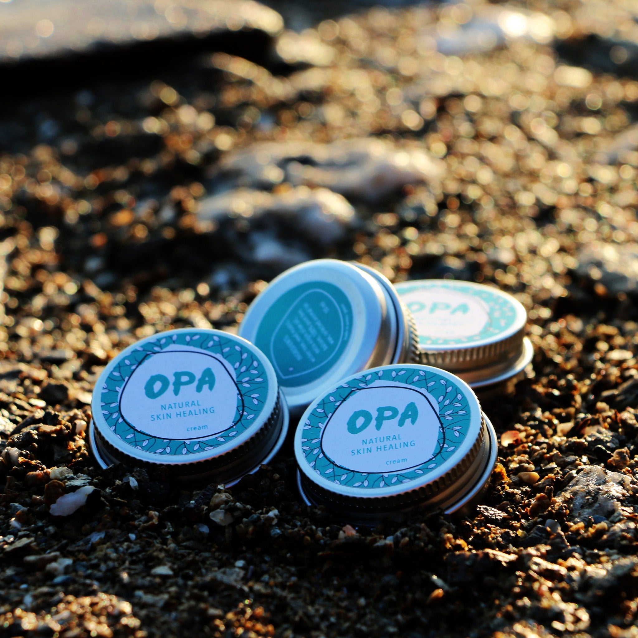 Skin care cream with blue and silver lids, OPA brand name visible on label