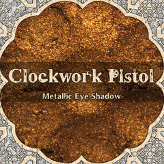 Metallic orange gold vegan loose powder eyeshadow in steampunk-inspired packaging with reflective finish