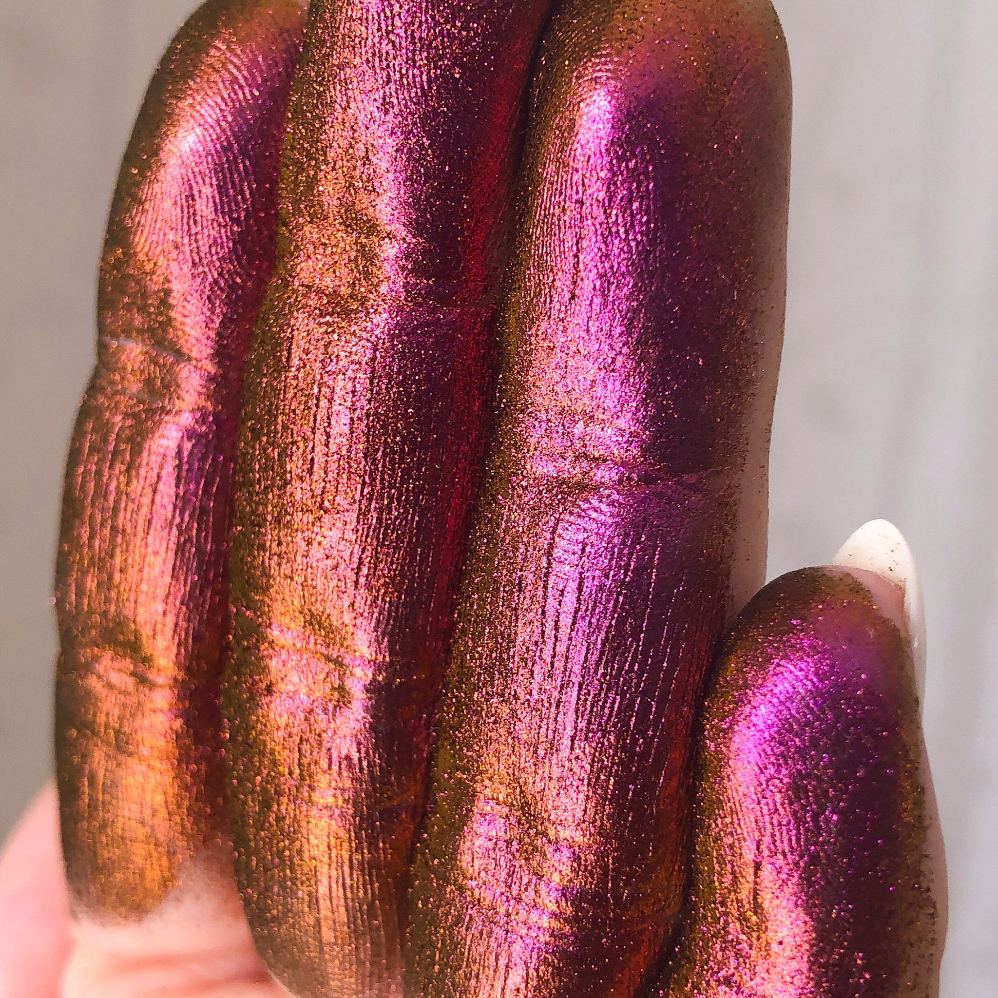 Close-up of Tala Chromatic Sunset Eye Shadow Pigment pot showing vibrant orange and pink shimmer texture