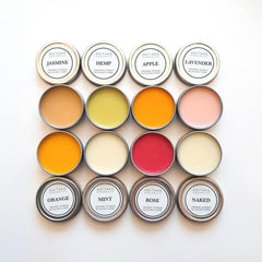 Lip balms in metal tins with various colors and ANITAKO ORGANICS branding on white background