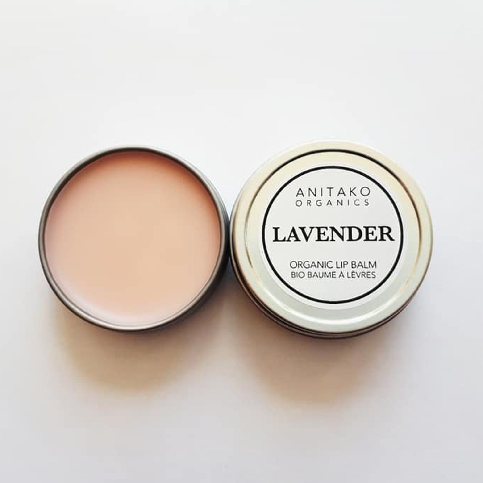 Lip balm in round metal tins, light pink balm, ANITAKO ORGANICS label visible