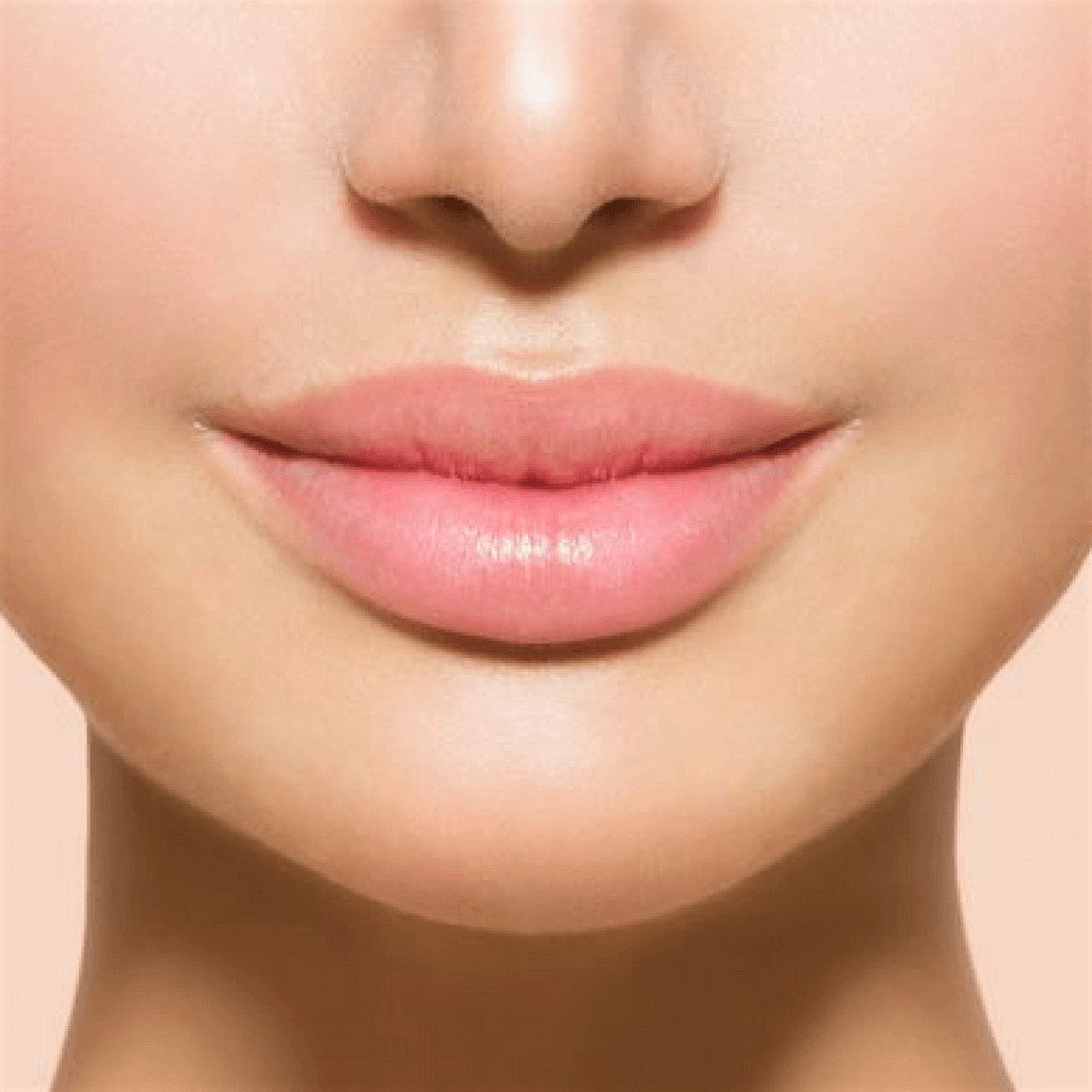 Lips with pink color and smooth texture, close-up view of face
