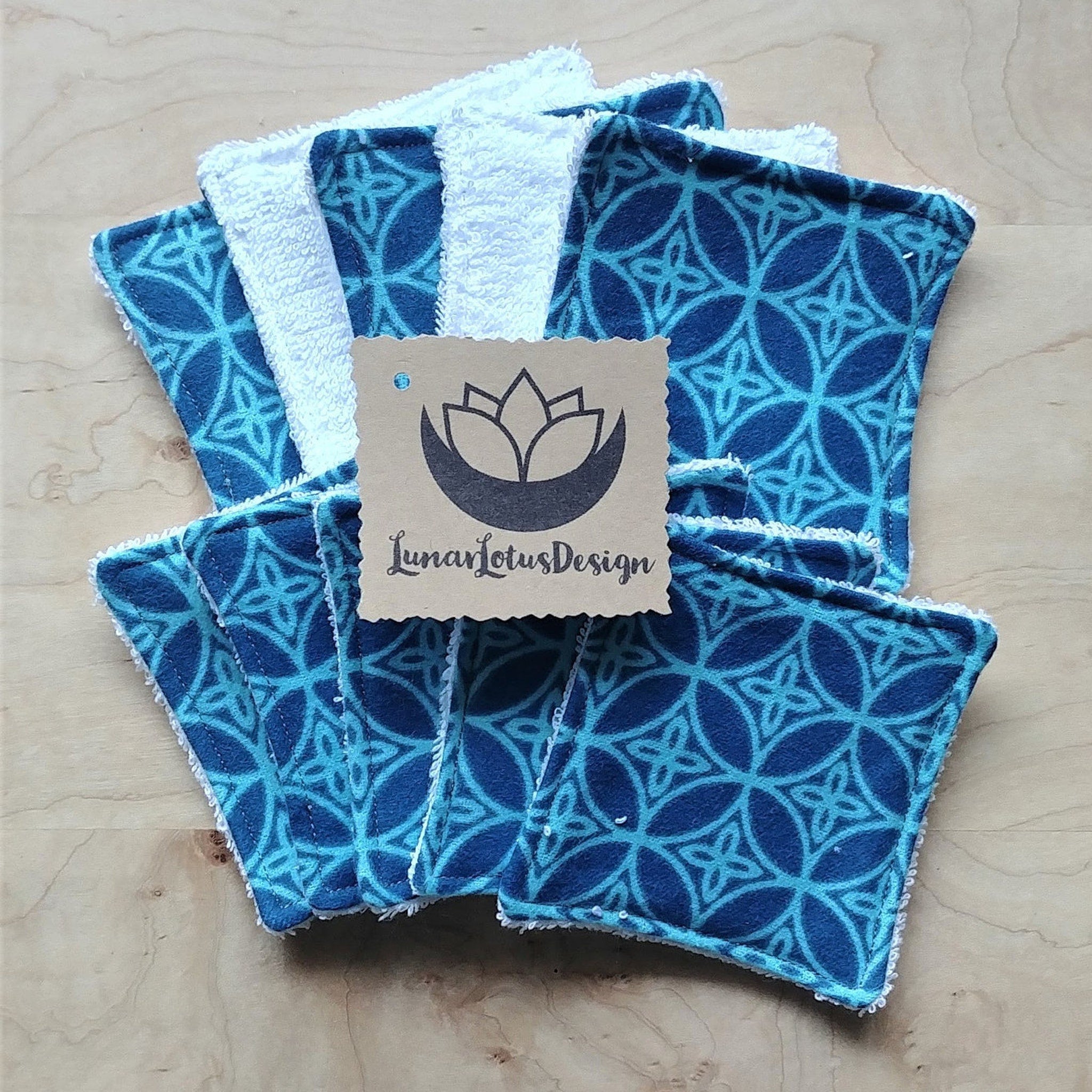 Reusable face cloths, blue patterned fabric with white trim, Lunar Lotus Design tag