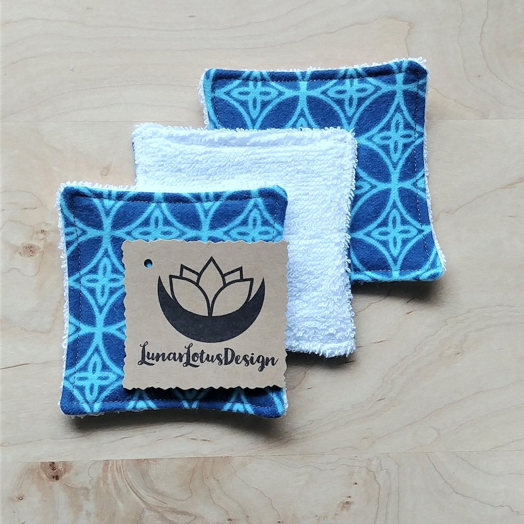 Reusable face cloths with blue geometric pattern, white terry cloth, Lunar Lotus Design tag