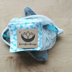 Reusable facial rounds with blue floral pattern, white mesh bag, and Lunar Lotus Design tag