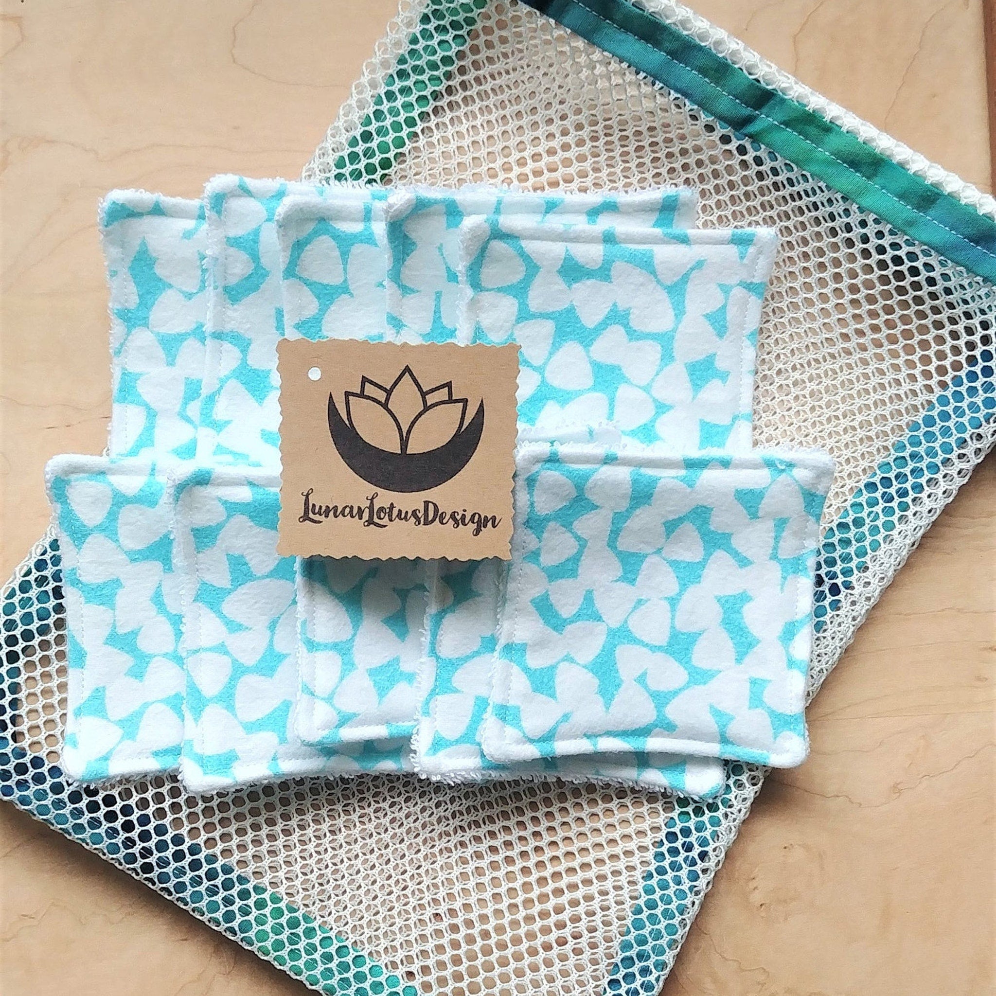 Reusable facial rounds with blue and white floral pattern, white trim, and Lunar Lotus Design tag.