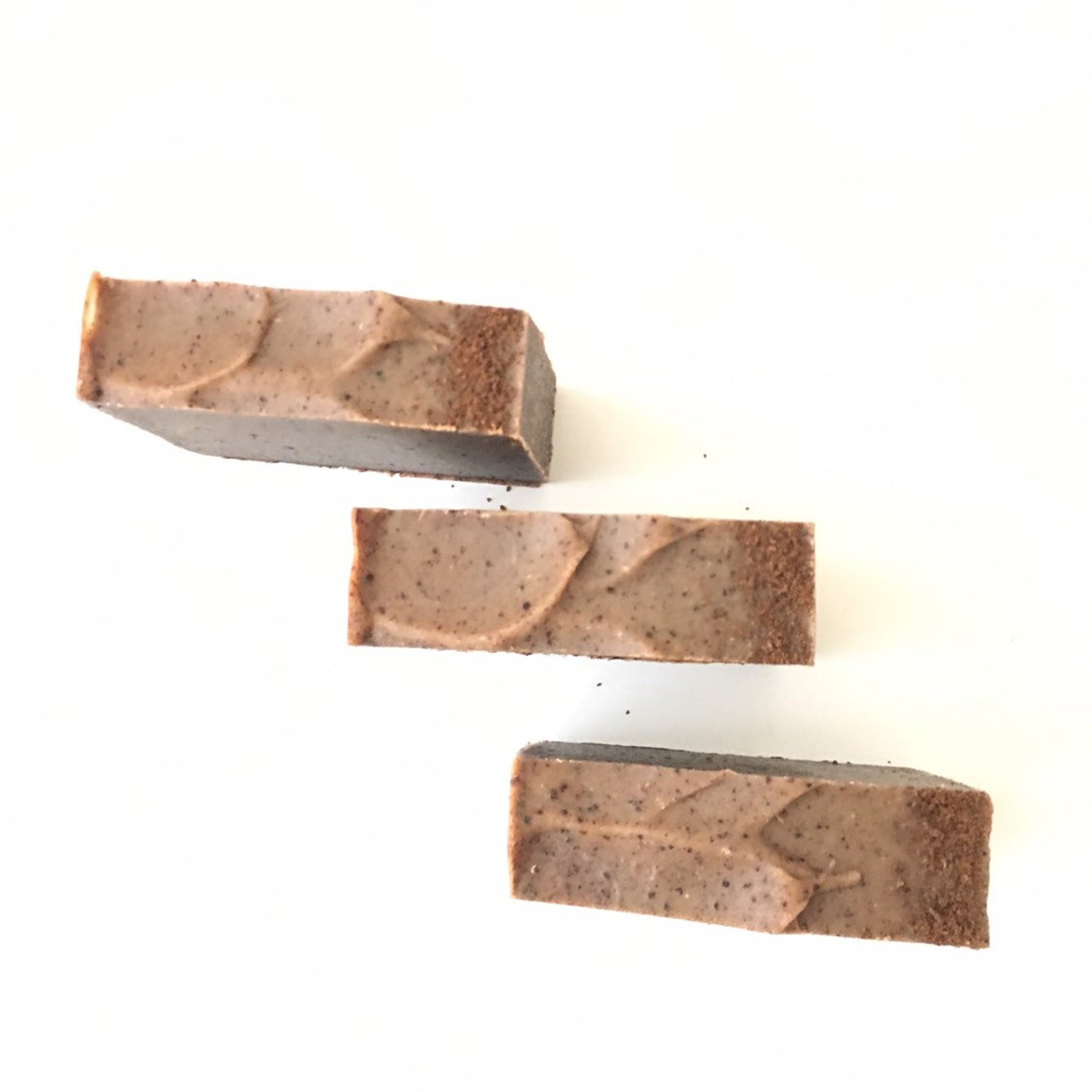 Soap bars with brown color, textured edges, and wavy pattern on top