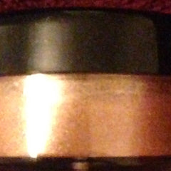 Close-up of Piccoli Piaceri mineral eyeshadow in warm hazelnut pearl with shimmering flecks and smooth pressed powder texture