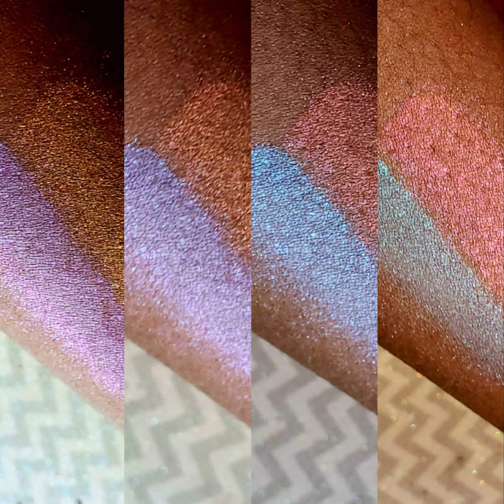 Swatches of iridescent pink, blue, and gold shimmer on skin, showing color variations
