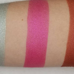 Side angle view of vegan bubblegum pink pressed eyeshadow in compact palette showing smooth matte texture