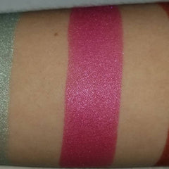 Close-up of vegan bubblegum pink pressed eyeshadow being applied to eyelid with brush