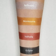 Side angle of vegan silver blue pressed eyeshadow pan with reflective shimmer in compact case