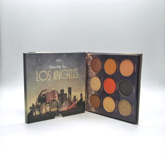 Eyeshadow palette with multiple colors, brand name Mavie, and Los Angeles design on the cover