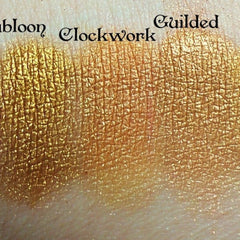 Side view of Gold Dubloon eyeshadow pan showing rich metallic finish and embossed logo details
