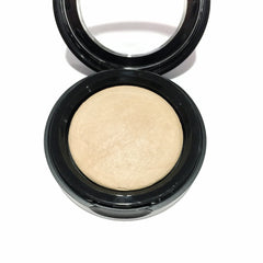 Close-up of French Vanilla baked eye shadow showing creamy beige powder with subtle shimmer in compact case