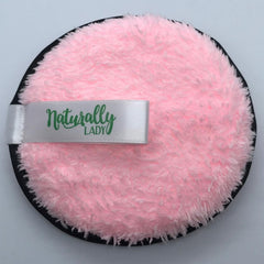 Makeup remover pad with pink fluffy material, black trim, and white Naturally Lady ribbon