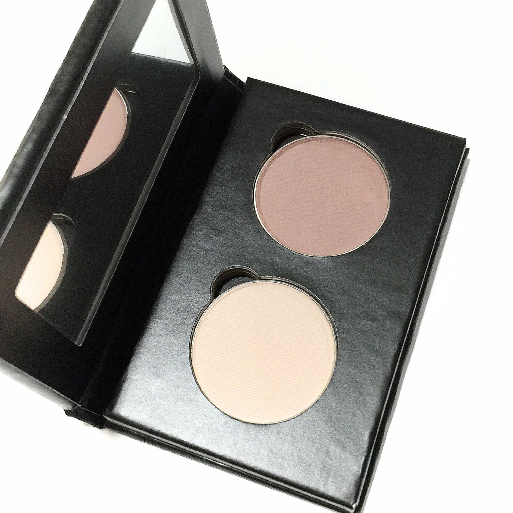 Side view of pink bisque eye shadow duo in paperboard palette showing compact size and matte finish