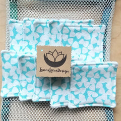 Reusable face pads with teal and white floral pattern, white trim, and Lunar Lotus Design tag