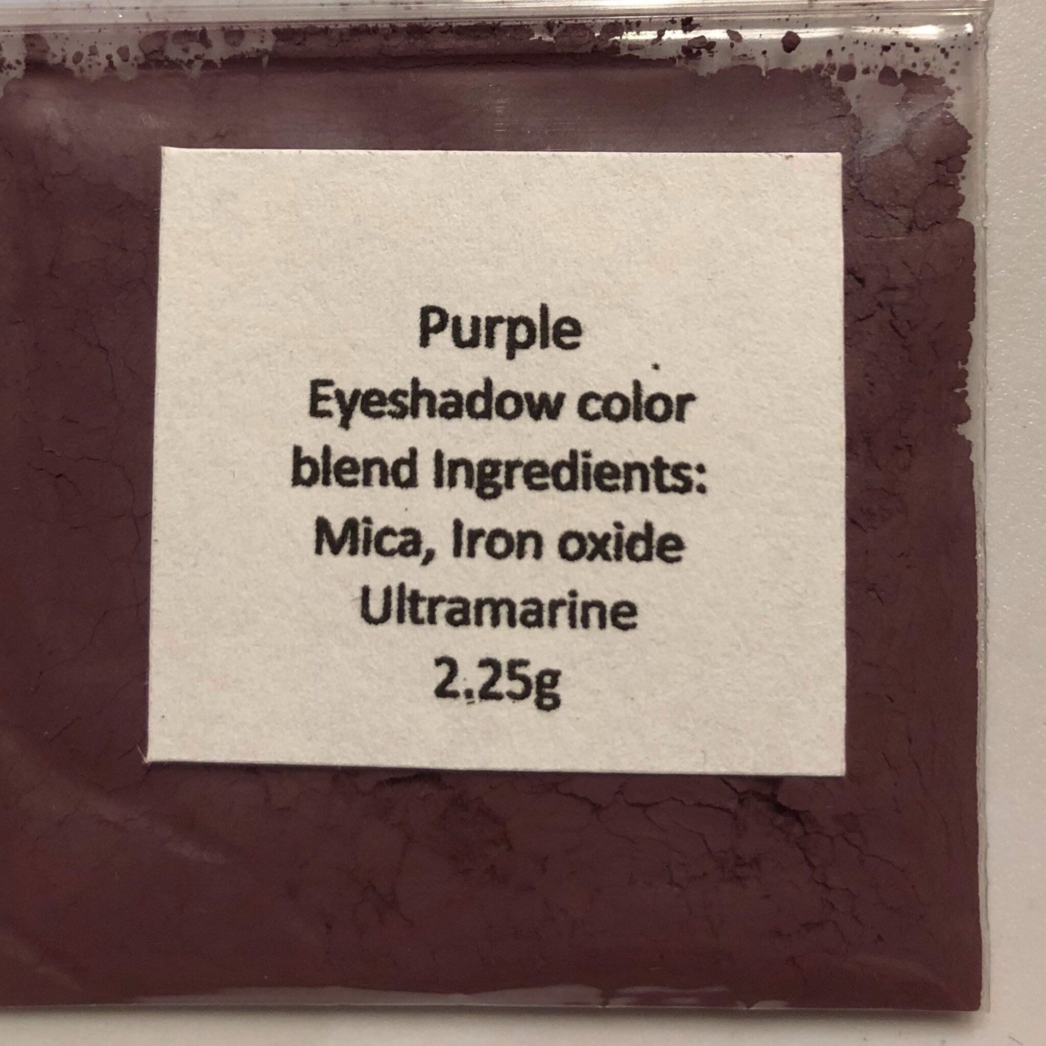 Side view of mineral eyeshadow palette showing soft matte pink and taupe shades in compact case