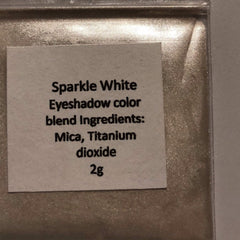 Close-up of mineral eyeshadow palette showing soft matte pink and taupe shades with smooth blendable texture