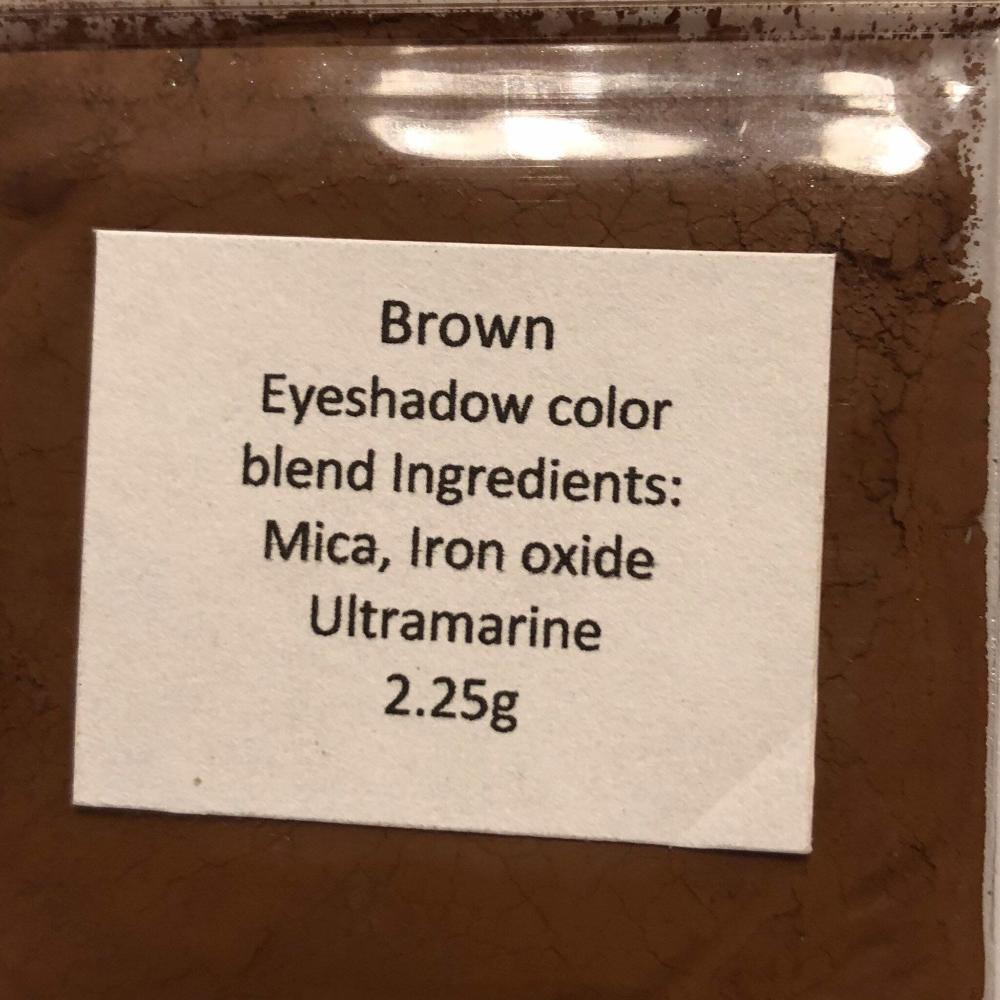 Close-up of mineral eyeshadow palette showing smooth powder texture and natural earthy tones blending seamlessly