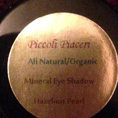 Close-up of Piccoli Piaceri Mineral Eyeshadow in Hazelnut Pearl, showcasing warm brown shimmer in compact case
