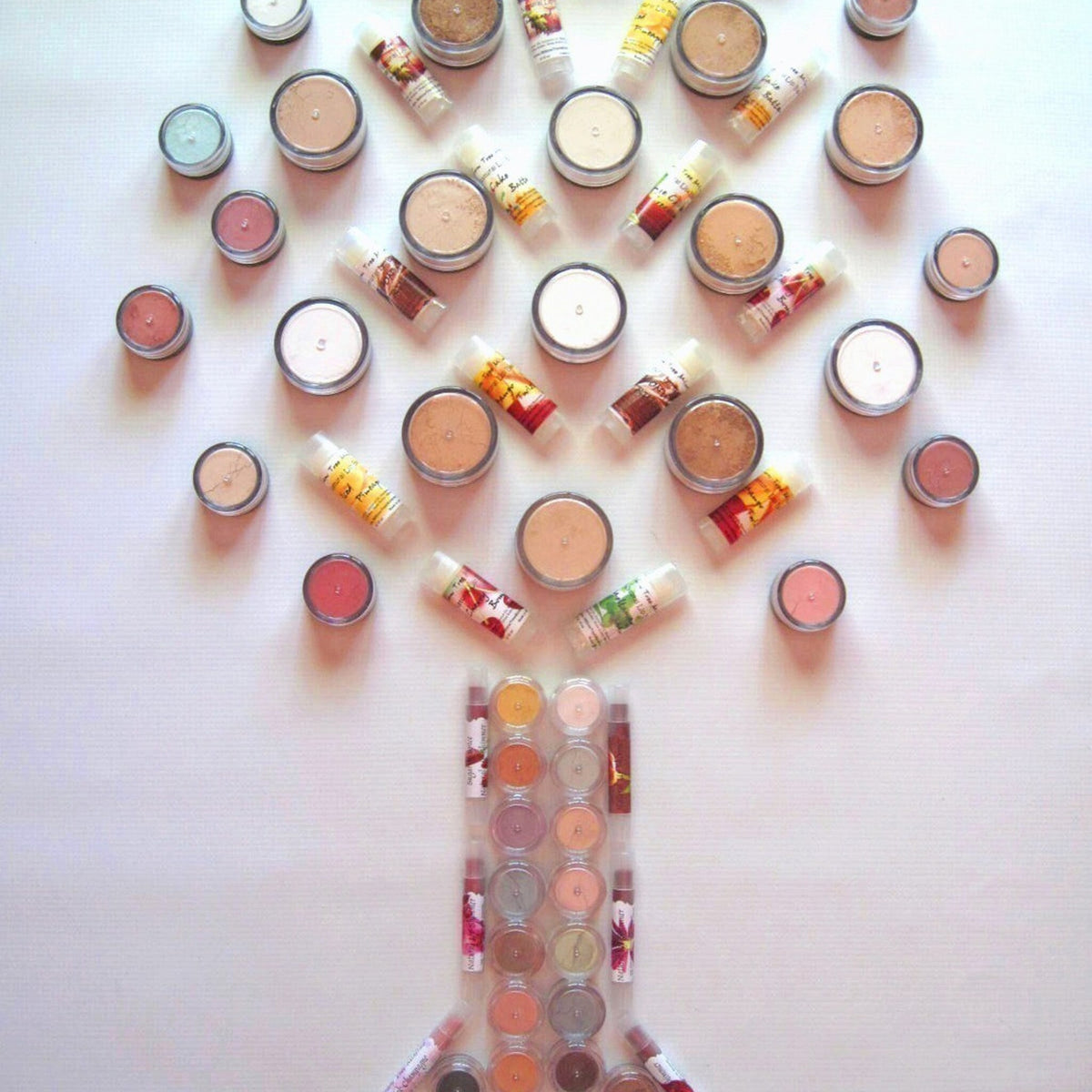 Six small resealable bags of mineral eyeshadow samples in various earthy tones displayed on a neutral background